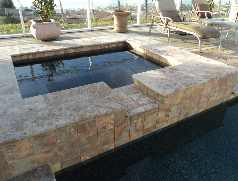 After-Spa and pool remodel - travertine, tile and pebble finish